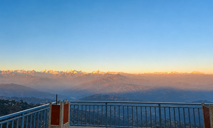 Sunrise view from Stillpoint terrace with mountains glowing in golden light